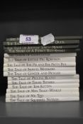 A collection of Beatrix Potter books, some without dust covers.