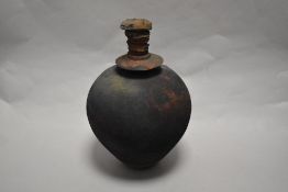 A spherical studio bottle with stopper, having textured finish, with Belgium label for Marc