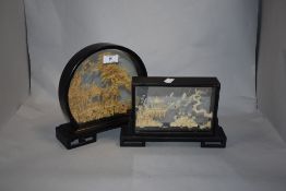 Two vintage oriental carvings within glass cases.