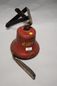 An early 20th century Fire bell with leather strap to clapper and wall bracket.