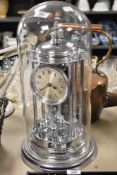 A Schatz chromed metal perpetual motion mantel clock, the silvered dial having arabic numerals,
