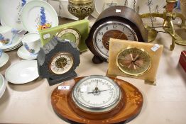 An Edwardian mahogany and inlaid aneroid barometer, measuring 27cm wide