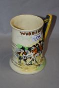 A Crown Devon 'Widdicombe Fair' relief moulded tankard, measuring 15cm tall