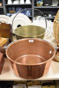 Two 19th Century copper and brass jam pans, the largest measuring 38cm tall