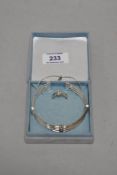 A silver coloured jewellery set, to comprise a matching ring and bangle