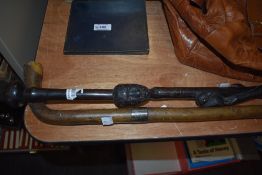 A carved African hardwood cane, having bird and head to shaft, sold with another cane of traditional