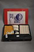 A game of Mah-Jong in case, with instructions.