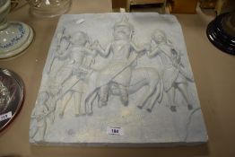 An ethnic carved ceramic plaque, on light blue ground, and decorated in relief with a scene from '