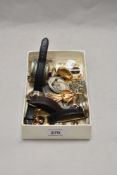 A box of decorative jewellery, wristwatches, and associated items, including a filigree lidded