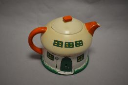 A Mabel Lucie Atwell Shelley pottery teapot, having vibrant Pixie and cottage design.