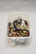 A box of decorative costume jewellery, to include an Eastern gold coloured circular pendant,