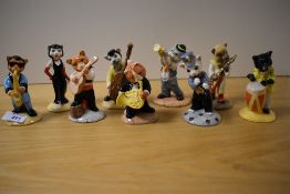 Nine Beswick Pottery cat studies playing instruments.
