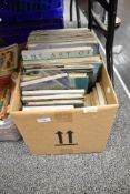 A box of maritime themed books and publications, including 'The Art of Nautical Illustration', '
