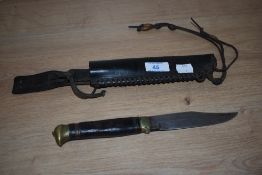 A Bowie Knife with leather grip and scabbard, the blade inscribed 'Original Bowie Knife'