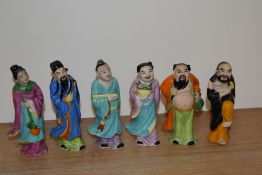 Six glazed pottery Chinese figural ornaments, hand painted and to represent the eight immortals,