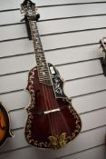 An unbranded Octave Mandolin/Mandola having wine read finish with extensive mother of pearl inlay