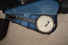 A vintage banjo ukulele, labelled to reverse of headstock for Clifford Essex