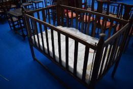 An early 20th Century oak Arts and Crafts cot, believed to be Liberty, bearing label W & S patent,