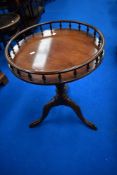 A reproduction wine table having spindle gallery