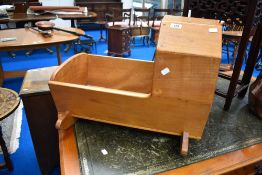 A vintage stained frame rocking cot of small proportions
