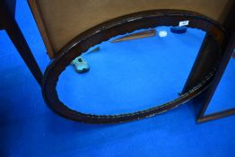 An early 20th Century mahogany oval mirror