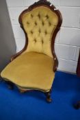 A Victorian mahogany nursing chair having knurl frame and gold dralon upholstery