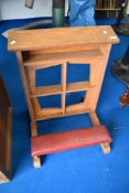 A traditional golden oak prayer rail with padded kneeler, originally from Blackburn Cathedral