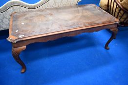A reproduction walnut and glass topped coffee table