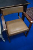 A vintage stained frame armchair in the municipal style