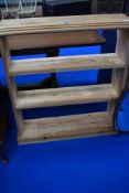A natural pine open bookshelf