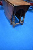 A period oak drop leaf dining table having turned gate legs
