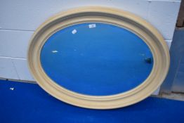 A vintage oval wall mirror