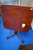A 19th Century pedestal occasional table having square top on turned column and triple splay legs