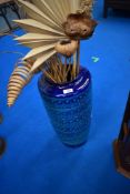 A German floor vase and dried floral arrangement