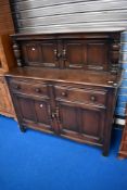 A vintage dark stained Ercol or similar court cupbpard