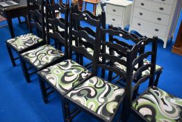 A Harlequin set of 9 ladder back dining chairs , with vintage style paint and upholstery