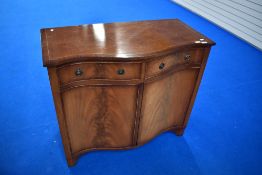 A reproduction Regency serpentine front narrow sideboard, width approx. 100cm