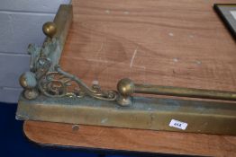 An early 20th Century brass fire fender