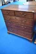 A 19th Century chest of two over three drawers, having brass drop handles and bracket feet, width