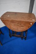 An early 20th Century oak twist gate leg occasional table