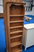 A modern narrow pine shelf unit