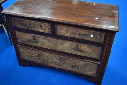 A late 19th or early 20th Century mahogany and walnut chest of two over two drawers