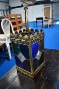 A vintage brass and coloured glass lantern style ceiling light fitting