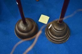 A pair of traditional copper possers having stained frame handles