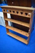 A traditional pine delft rack with heart motif to frieze