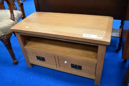 A modern golden oak effect TV stand