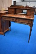 An Edwardian mahogany and inlaid dressing table or desk having central mirror flanked by two