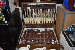 A selection of bone handled cutlery in oak canteen