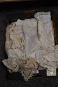 A selection of vintage table linen, including embroidered table cloth and crochet edged mats and