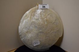 A Victorian mother of pearl carved shell, illustrating scenes relating to the Crucifixion, measuring